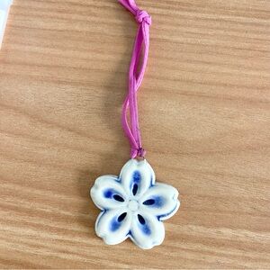 Handmade pottery blue flower ornament charm